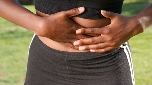 Person holding their stomach area due to gut pain