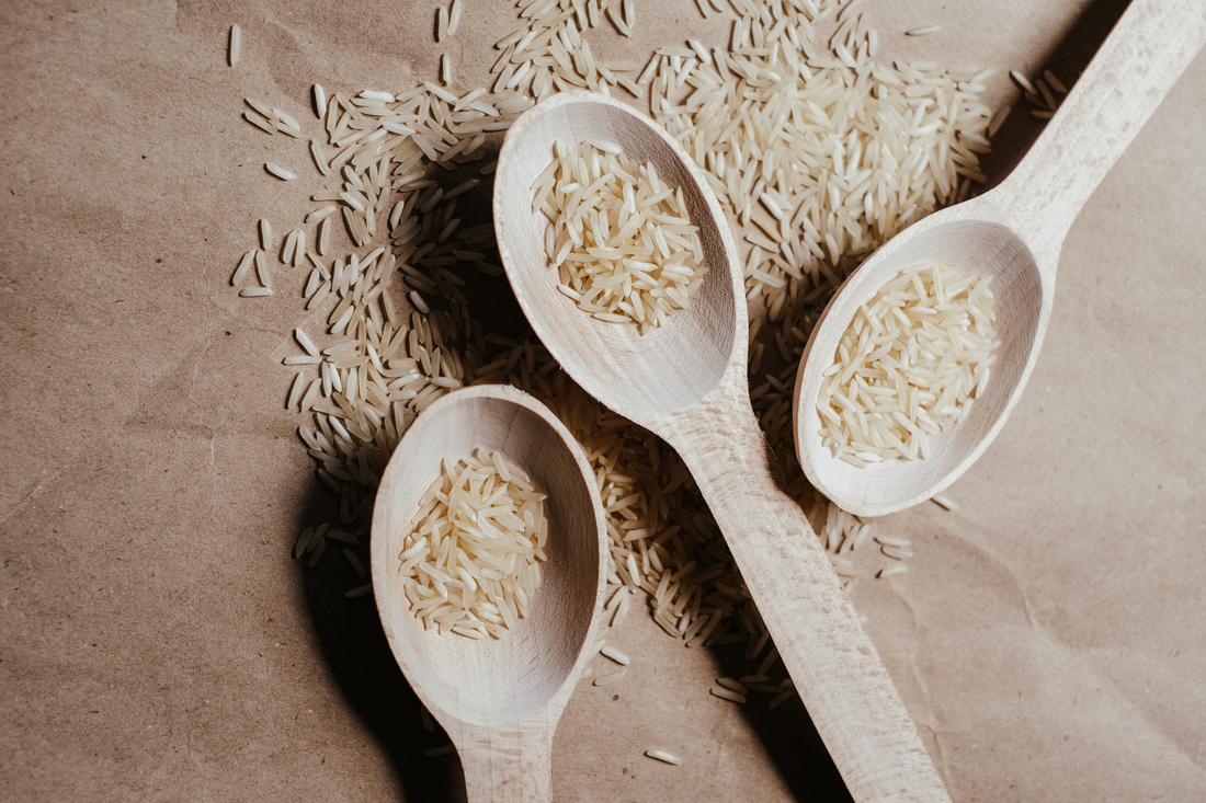 Spoons of uncooked white rice