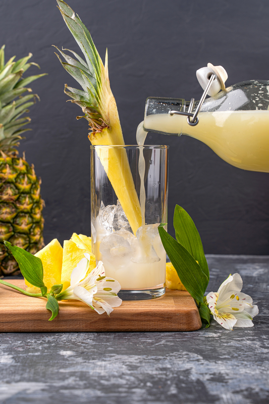 Pineapple mocktail drink with pineapple juice, lime juice, coconut milk, and ice