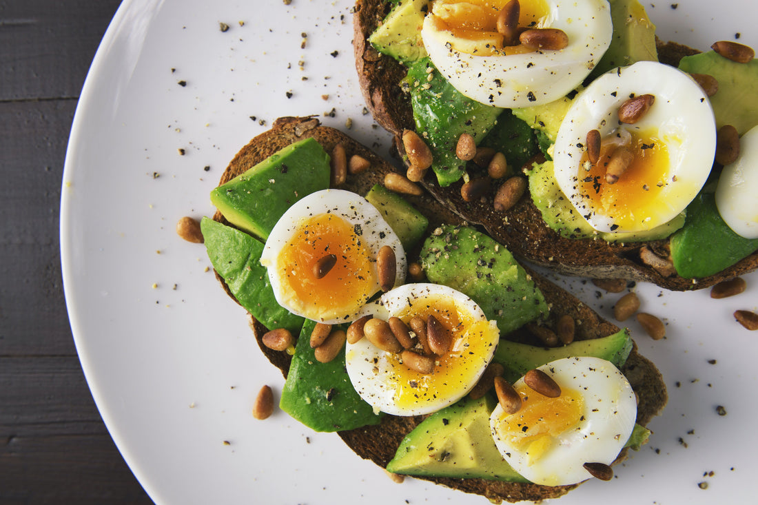 Avocado toast with eggs, black pepper, and nuts