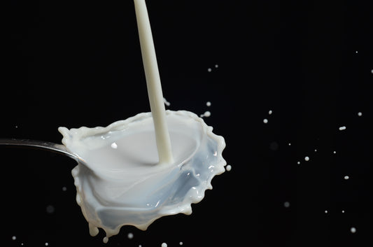 Milk spilling onto a spoon
