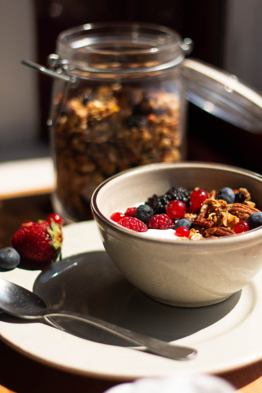 Bowl of oatmeal with blueberries, raspberries, cranberries, nuts, and granola