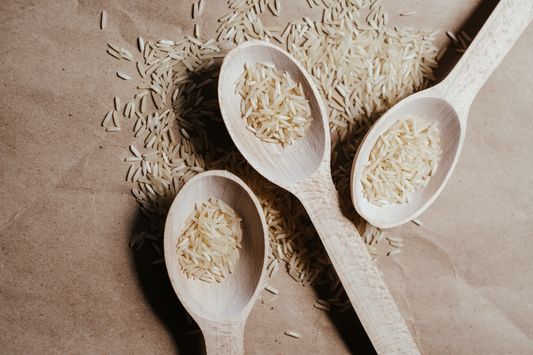 Spoons of uncooked white rice