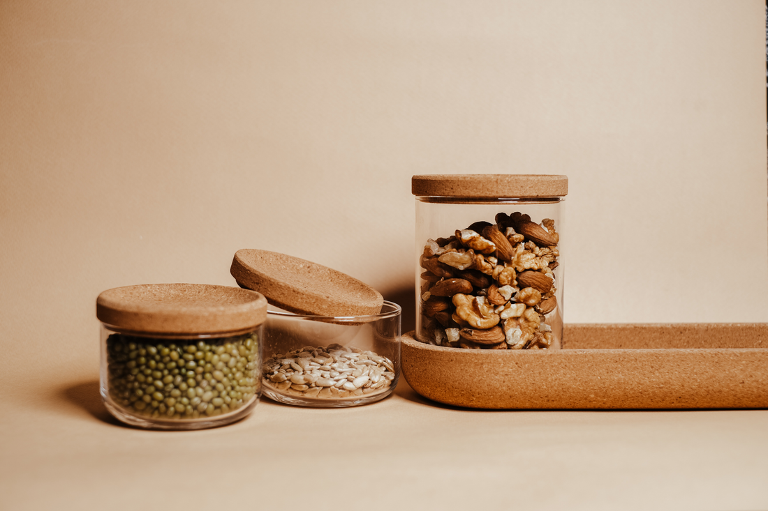 Glass containers of beans, nuts (cashews, walnuts, almonds), and seeds